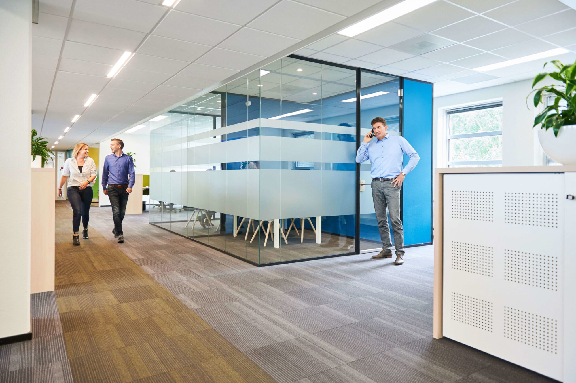 Drie NOM collega's op het kantoor van de NOM