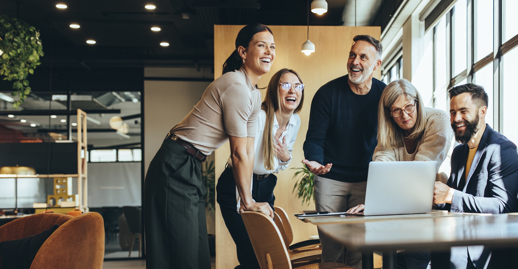 appy,Businesspeople,Laughing,While,Collaborating,On,A,New,Project,In