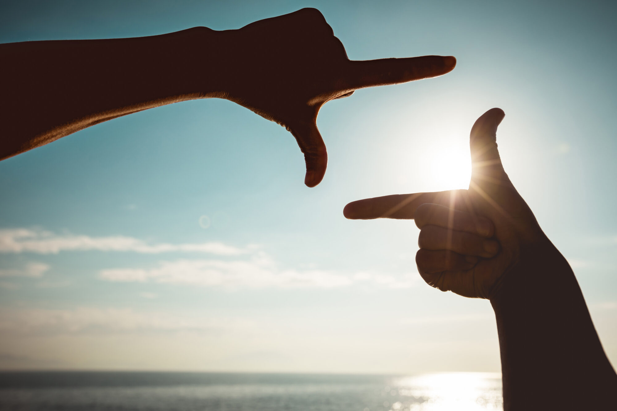 Holding,Hands,In,A,Frame,Shape,Against,Sunrise,Sky