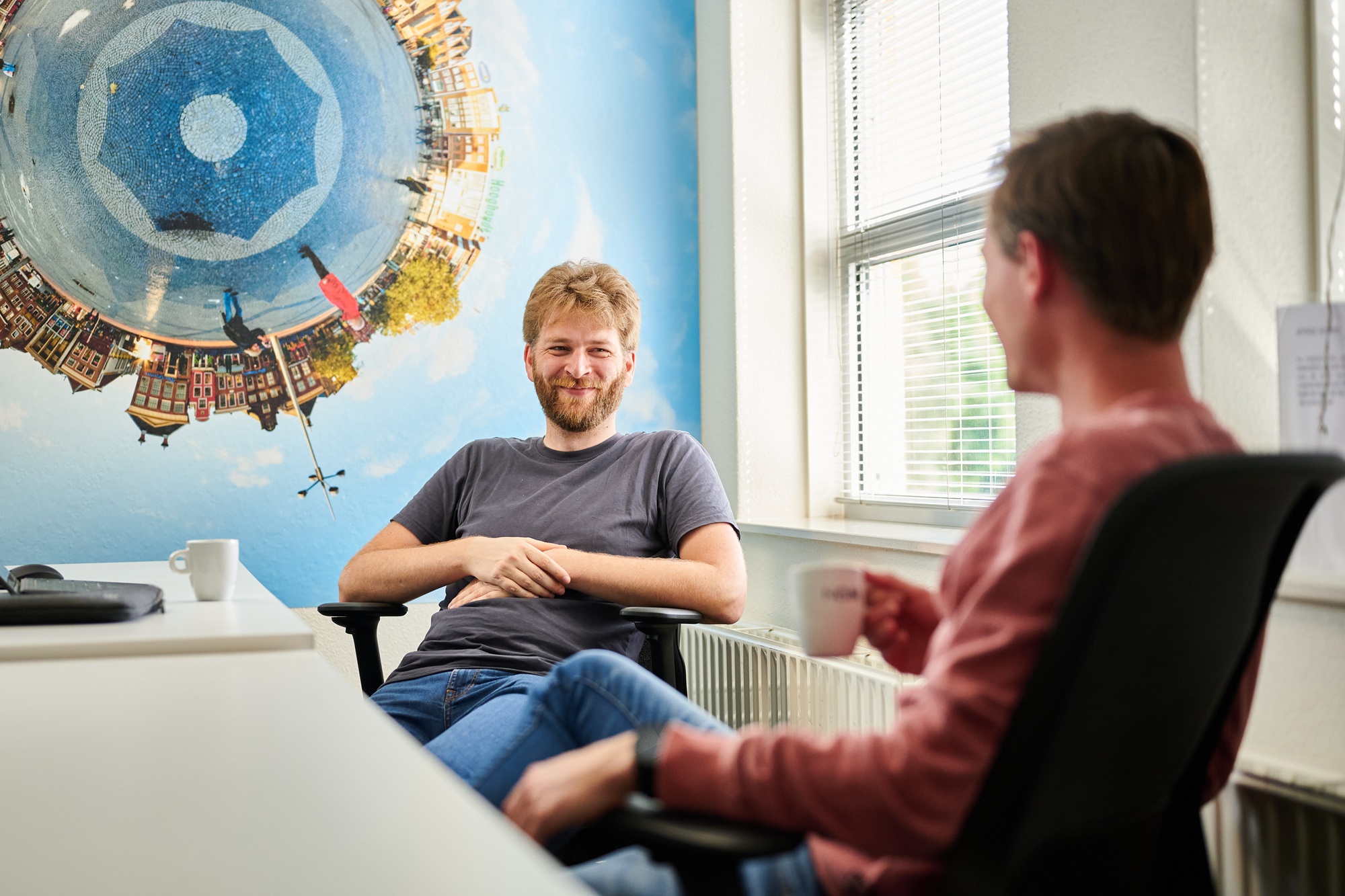 Twee NOM collega's met elkaar in gesprek